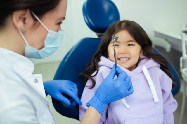 A child and dentist sharing a fun moment at Victor Crescent Dental Clinic in Narre Warren, making dental visits enjoyable and comfortable for young patients.
