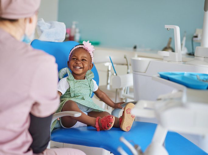 A young child smiling at the dentist during a pediatric dental visit at Victor Crescent Dental Clinic in Narre Warren, ensuring a comfortable and positive experience for kids.