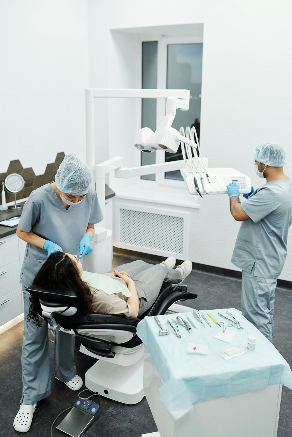 Efficient Dental Care at Victor Crescent Dental Clinic, Narre Warren A dentist and her assistant working together efficiently on a patient at Victor Crescent Dental Clinic in Narre Warren, ensuring a quick and smooth dental procedure with expert teamwork.