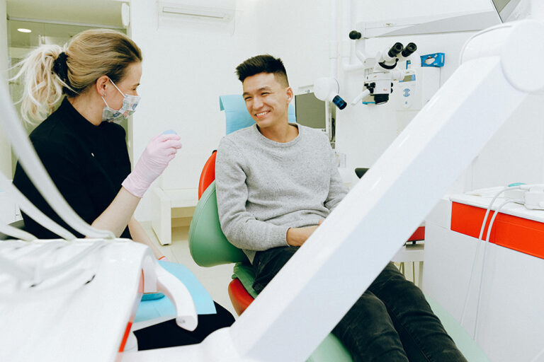 A dentist and patient smiling at each other after a successful dental procedure at Victor Crescent Dental Clinic in Narre Warren, ensuring a comfortable and positive treatment experience.