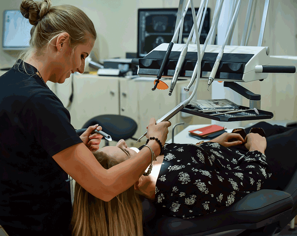 A skilled dentist providing dental treatment to a patient at Victor Crescent Dental Clinic in Narre Warren, ensuring comfort and high-quality care during the procedure.
