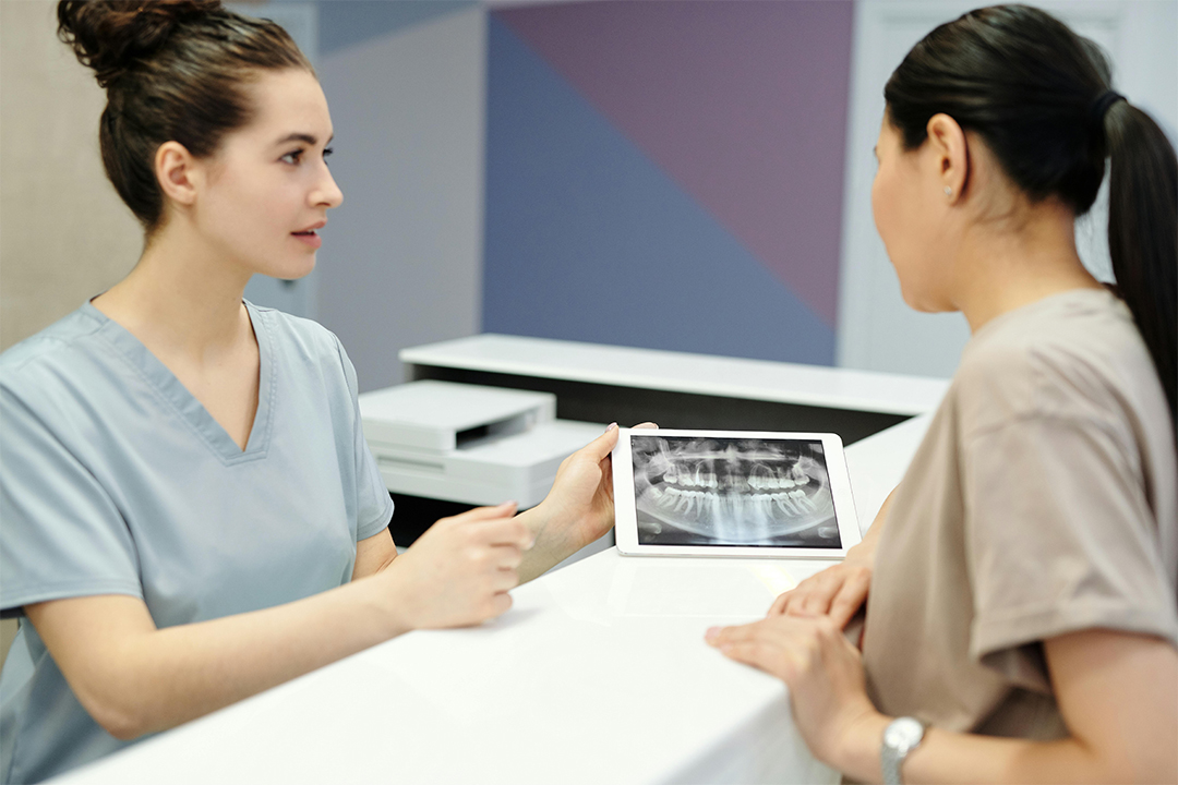 A dentist and assistant analyzing a dental X-ray at Victor Crescent Dental Clinic in Narre Warren, using advanced technology to ensure accurate diagnoses and treatment planning.
