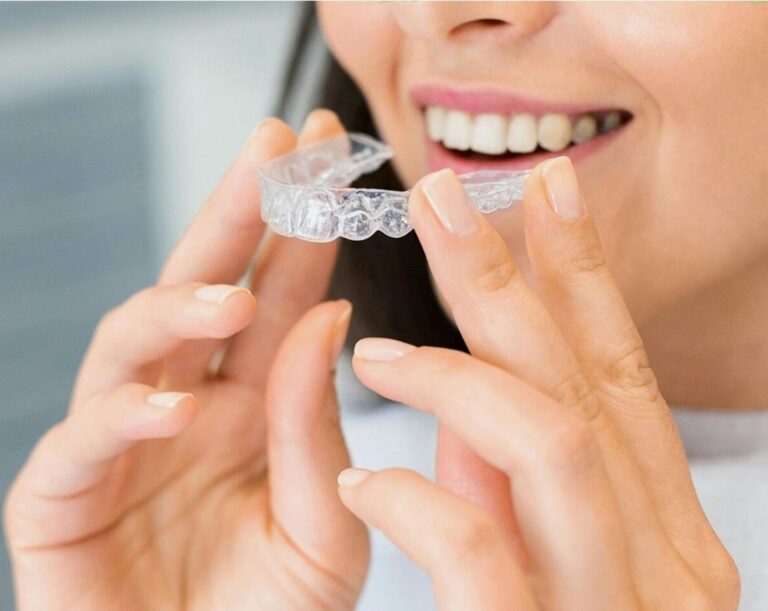 A patient putting on her Invisalign clear aligners at Victor Crescent Dental Clinic in Narre Warren, offering discreet and effective teeth straightening solutions.