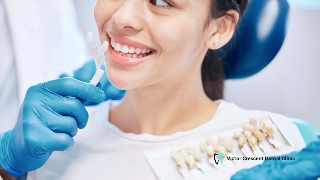 Dentist checking a patient's veneer shade with a guide at a Dental Clinic in Pakenham.